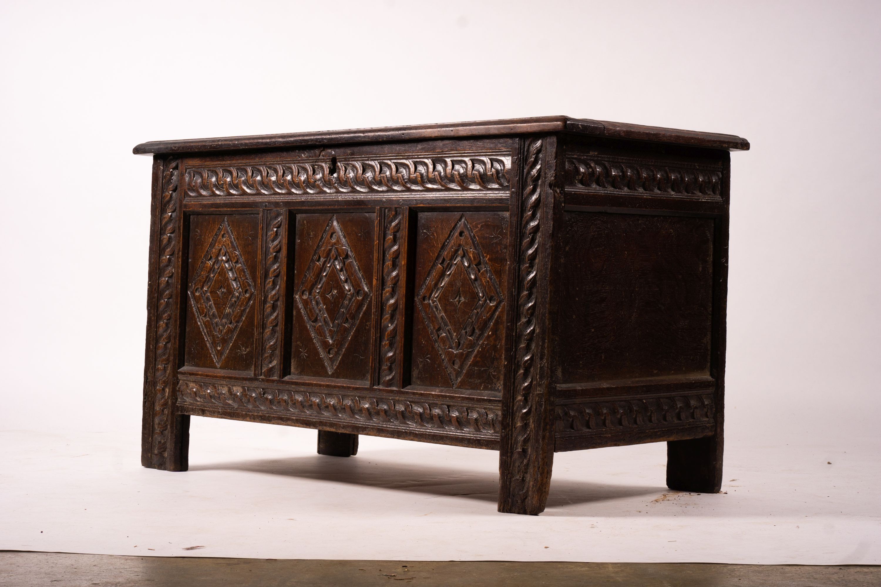 A 17th century carved panelled oak coffer, length 115cm, depth 56cm, height 67cm